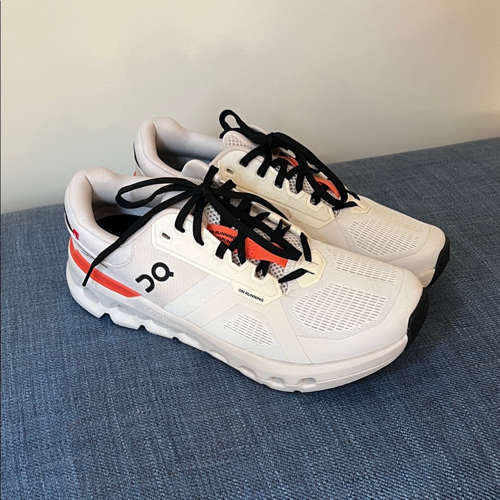 On Running White Sneakers with Orange and Black Accents